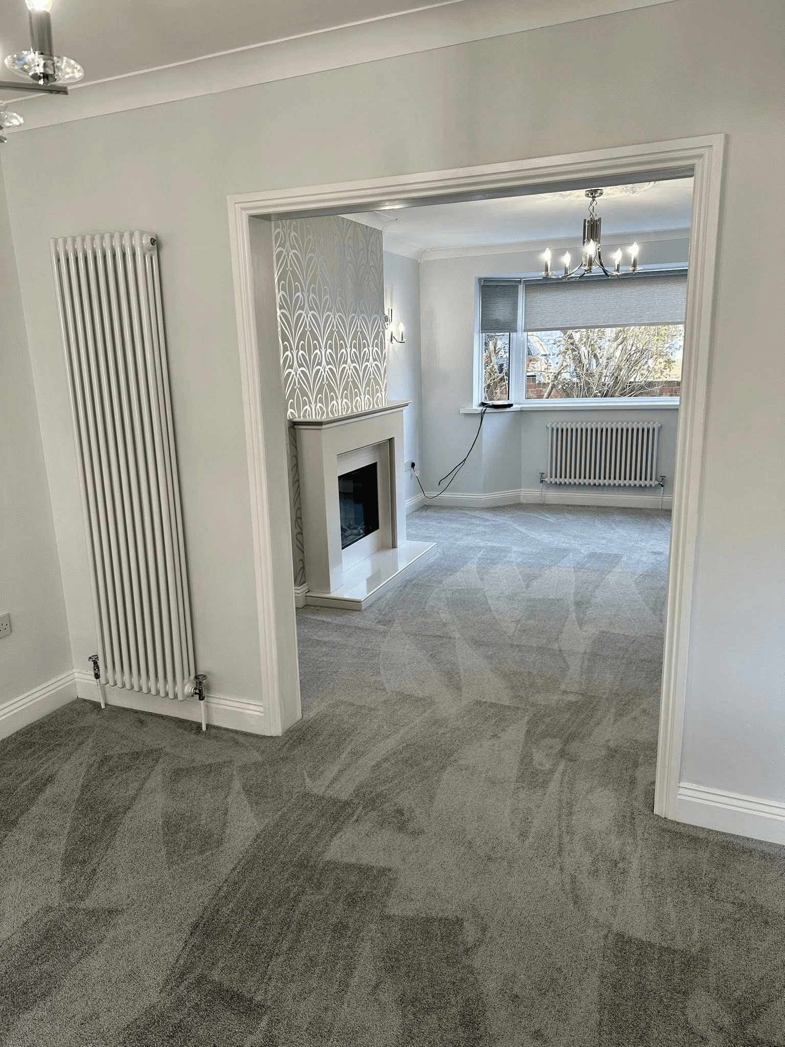 Light grey carpet fitted across open-plan lounge and dining room