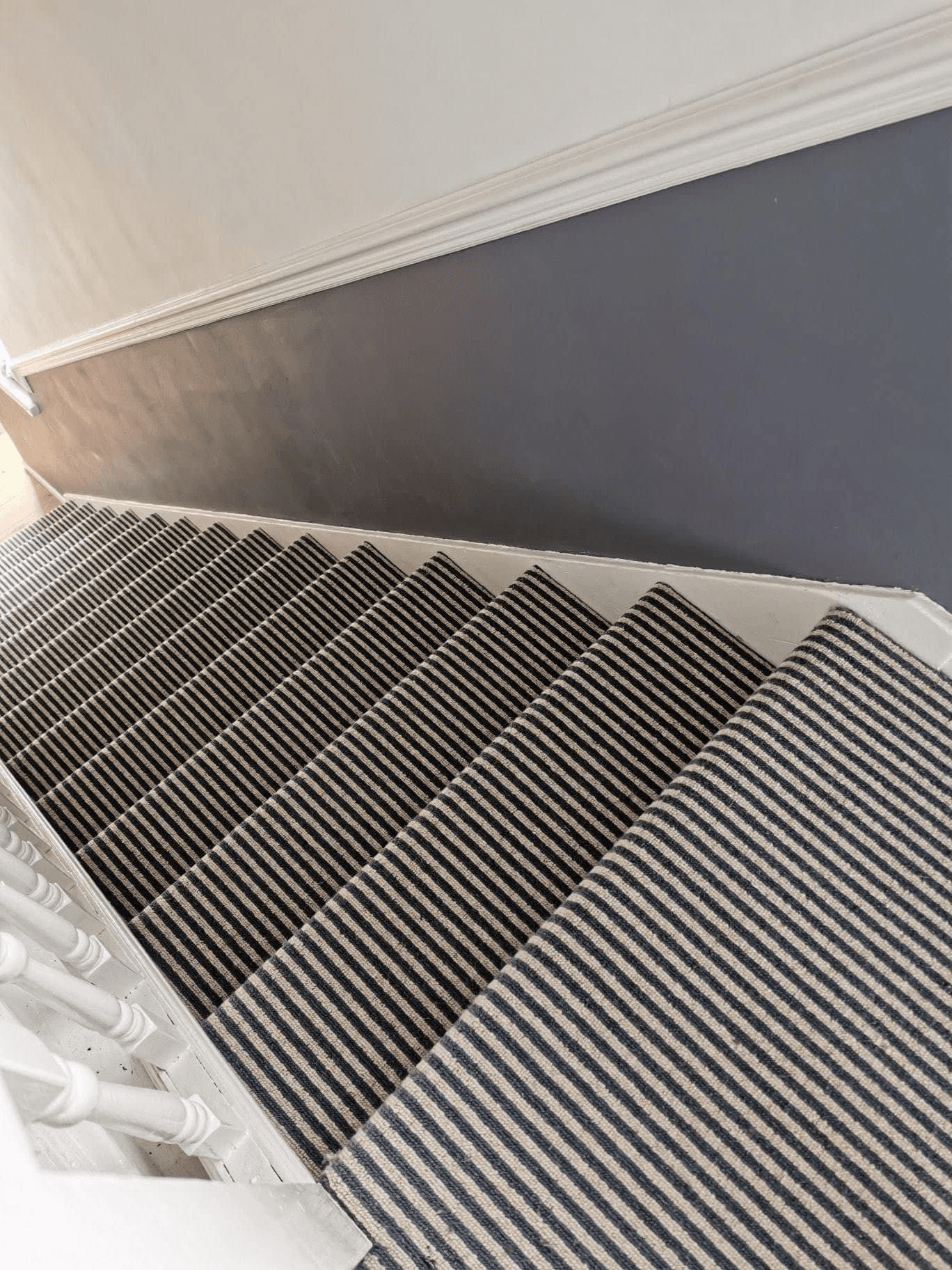Navy and cream striped stair runner carpet fitted on staircase